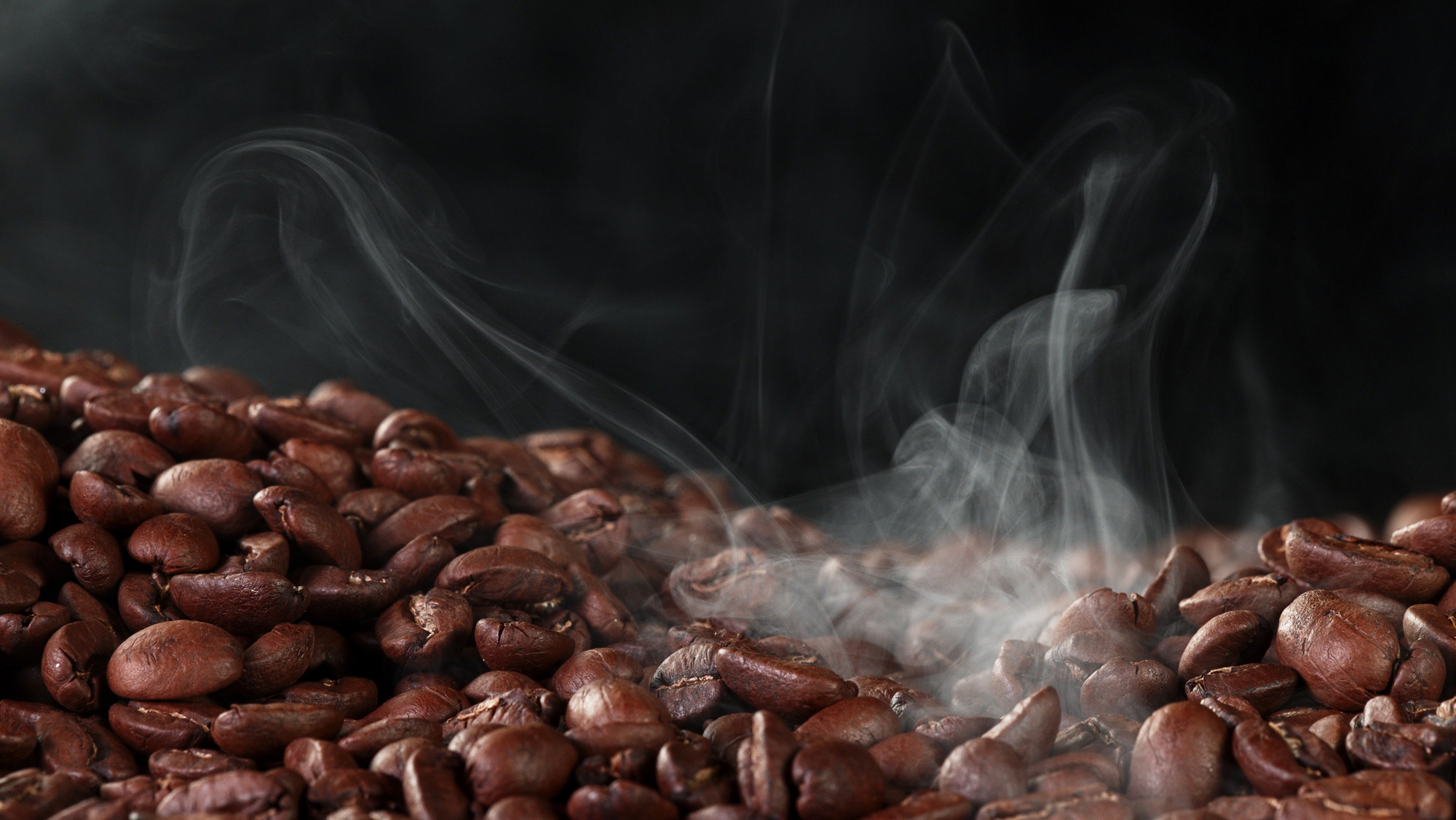 Pile of Fresh Roasted Coffee Beans with Smoke